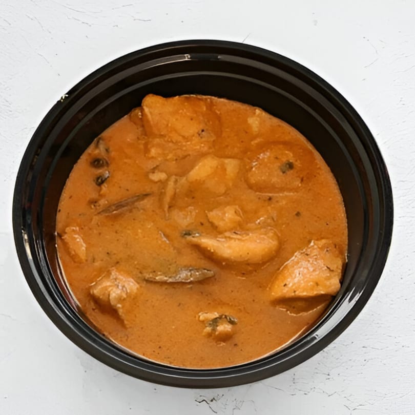 AniKri Foods' Indian chicken curry with spices and herbs in a black bowl.