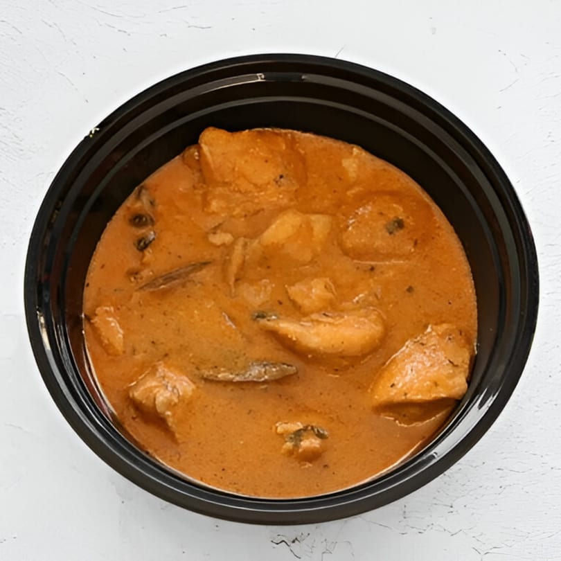 AniKri Foods' Indian butter chicken or curry in a black takeout container on a white surface.